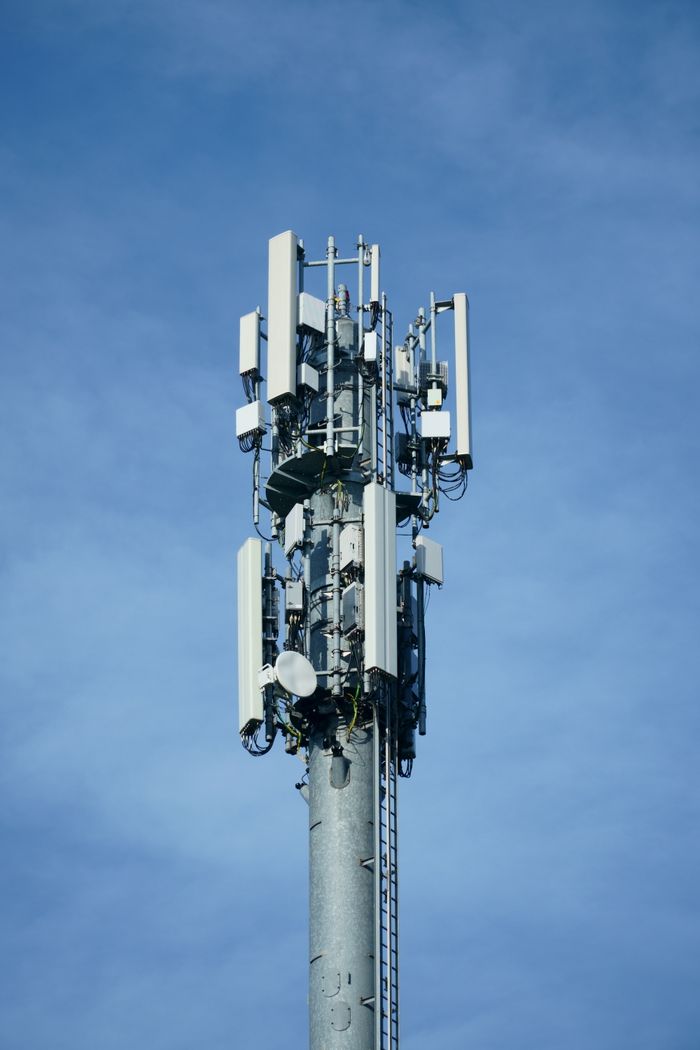 The Art of Drawing Readers In: Your attractive post title goes here Telecommunication transmission tower with multiple antennas against a clear blue sky, showcasing modern connectivity technology.