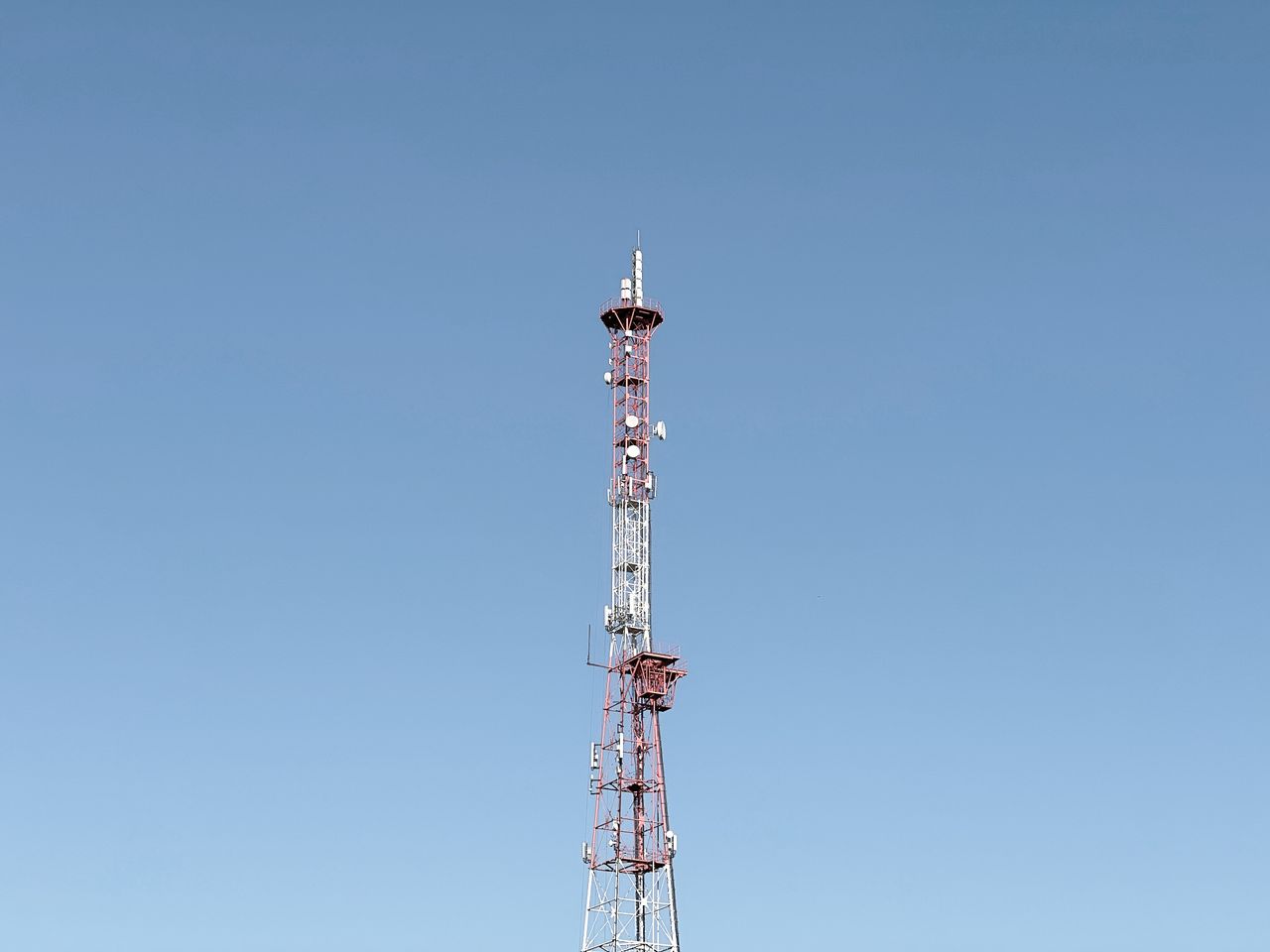Crafting Captivating Headlines: Your awesome post title goes here A tall communication tower set against a cloudless blue sky, symbolizing modern telecommunications.